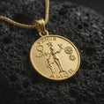Load image into Gallery viewer, Gold plated Venus Amor pendant necklace presented on porous volcanic rock, highlighting the classical love and beauty symbolism in a luxurious close-up jewelry image.