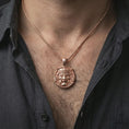 Load image into Gallery viewer, A rose gold plated Oni pendant worn on the neck, warm metallic tone enhancing the sculpted mask expression.