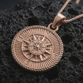 Load image into Gallery viewer, Rose gold plated steampunk compass pendant necklace on dark volcanic rock, photographed in a detailed premium studio macro view.