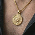 Load image into Gallery viewer, Gold plated steampunk compass pendant necklace worn on the neck, captured on a human model in a premium dark-toned lifestyle frame.