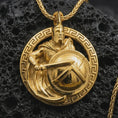 Load image into Gallery viewer, Gold plated Spartan warrior pendant necklace presented on porous volcanic rock, highlighting the ancient Greek battle motif in a luxurious close-up jewelry image.