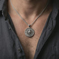 Load image into Gallery viewer, Polished silver compass rose pendant necklace worn on the neck, shown against the chest in a clean and elegant everyday wear composition.