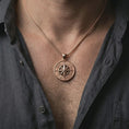 Load image into Gallery viewer, Rose gold plated compass rose pendant necklace worn on the neck, presented in a close-up lifestyle shot with a refined adventurous aesthetic.