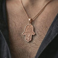 Load image into Gallery viewer, Rose gold plated Jerusalem Hamsa hand pendant necklace worn on the neck, presented in a close-up lifestyle shot with a refined spiritual aesthetic.