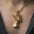Load image into Gallery viewer, Gold plated Nefertiti pendant necklace worn on the neck, captured on a human model in a premium dark-toned lifestyle frame.