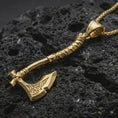 Load image into Gallery viewer, Gold plated battle axe pendant necklace presented on porous volcanic rock, highlighting the warrior-inspired axe silhouette in a luxurious close-up jewelry image.