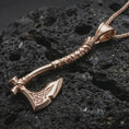 Load image into Gallery viewer, Rose gold plated battle axe pendant necklace on dark volcanic rock, photographed in a detailed premium studio macro view.
