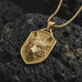 Load image into Gallery viewer, Gold plated fox shield pendant necklace presented on porous volcanic rock, highlighting the clever animal totem design in a luxurious close-up jewelry image.