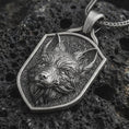 Load image into Gallery viewer, Sterling silver fox shield pendant necklace with an oxidized finish resting on textured volcanic rock, captured in a close-up premium studio composition.