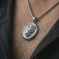 Load image into Gallery viewer, Polished silver lioness pendant necklace worn on the neck, shown against the chest in a clean and striking everyday wear composition.