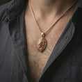Load image into Gallery viewer, Rose gold plated lion head pendant necklace worn on the neck, presented in a close-up lifestyle shot with a refined wildlife-inspired aesthetic.