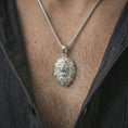 Load image into Gallery viewer, Polished silver roaring lion head pendant necklace worn on the neck, shown against the chest in a clean and striking everyday wear composition.