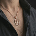 Load image into Gallery viewer, Rose gold plated Saint Francis pendant necklace worn on the chest, close-up lifestyle shot featuring the sacred Saint Francis design with warm rose gold tones.