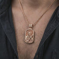 Load image into Gallery viewer, Rose gold plated Saint Andrew dog tag pendant necklace worn on the chest, close-up lifestyle shot featuring the sacred Saint Andrew design with warm rose gold tones.