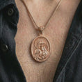 Load image into Gallery viewer, Rose gold plated Virgin Mary and baby Jesus pendant necklace worn on the chest, close-up lifestyle shot featuring the Virgin Mary and baby Jesus design with warm rose gold tones.