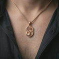 Load image into Gallery viewer, Rose gold plated cobra shield pendant necklace worn on the neck, presented in a close-up lifestyle shot with a refined mystical aesthetic.
