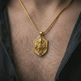 Load image into Gallery viewer, Gold plated kraken octopus shield pendant necklace worn on the neck, captured on a human model in a premium dark-toned lifestyle frame.