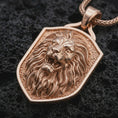 Load image into Gallery viewer, Rose gold plated roaring lion shield pendant necklace on dark volcanic rock, photographed in a detailed premium studio macro view.