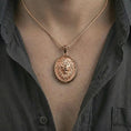 Load image into Gallery viewer, Rose gold plated lion medallion pendant necklace worn on the neck, presented in a close-up lifestyle shot with a refined wildlife-inspired aesthetic.