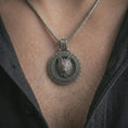 Load image into Gallery viewer, Oxidized Fenrir wolf pendant necklace worn on the neck, styled in a dark lifestyle portrait with an open shirt and bold Viking-inspired presentation.