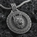 Load image into Gallery viewer, Sterling silver Fenrir wolf pendant necklace with an oxidized finish resting on textured volcanic rock, captured in a close-up premium studio composition.