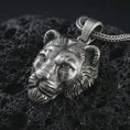Load image into Gallery viewer, Sterling silver 3D lioness pendant necklace with an oxidized finish resting on textured volcanic rock, captured in a close-up premium studio composition.