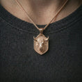 Load image into Gallery viewer, Rose gold plated bull head shield pendant necklace worn on the neck, presented in a close-up lifestyle shot with a refined zodiac-inspired aesthetic.