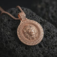 Load image into Gallery viewer, Rose gold plated Viking lion medallion pendant necklace on dark volcanic rock, photographed in a detailed premium studio macro view.