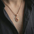 Load image into Gallery viewer, Wolf shield pendant necklace with a rose gold plated finish worn on the neck, shown in a close-up model photograph with a refined symbolic and rugged appearance.