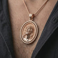 Load image into Gallery viewer, Rose gold plated spinning Jesus Christ pendant necklace worn on the chest, close-up lifestyle shot featuring the sacred Jesus Christ design with warm rose gold tones.