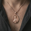 Load image into Gallery viewer, Rose gold plated Saint James the Apostle pendant necklace worn on the chest, close-up lifestyle shot featuring the sacred Saint James the Apostle design with warm rose gold tones.