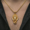 Load image into Gallery viewer, Gold plated Ganesha pendant necklace worn on the chest, premium lifestyle jewelry photo with the Ganesha pendant centered on a spiga chain.