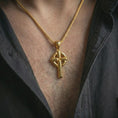 Load image into Gallery viewer, Gold plated Celtic cross pendant necklace worn on the neck, captured in a premium lifestyle composition with the cross pendant centered as a bold spiritual statement.