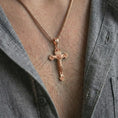 Load image into Gallery viewer, Rose gold plated crucifix pendant necklace worn on the neck, shown in a refined model photograph with an elegant Christian and devotional inspired look.