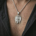 Load image into Gallery viewer, Polished silver angel warrior pendant necklace worn on the neck, shown in a refined model shot with the detailed guardian angel and sword pendant centered for a bold devotional look.