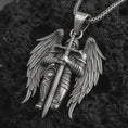 Load image into Gallery viewer, Oxidized angel warrior pendant necklace displayed on black volcanic stone, featuring a winged guardian holding a long sword in a bold and detailed sterling silver design.