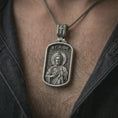 Load image into Gallery viewer, Oxidized Saint Jude dog tag pendant necklace worn on the chest, close-up lifestyle jewelry photo showing the Christian medallion on a spiga chain with dark clothing.