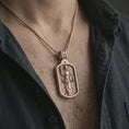 Load image into Gallery viewer, Rose gold plated Saint Dominic dog tag pendant necklace worn on the chest, close-up lifestyle shot featuring the sacred Saint Dominic design with warm rose gold tones.