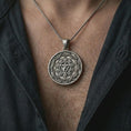 Load image into Gallery viewer, Oxidized Manipura chakra pendant necklace worn on the chest, close-up lifestyle jewelry photo showing the solar plexus medallion on a spiga chain with dark clothing.