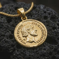 Load image into Gallery viewer, Gold plated Roman emperor coin pendant necklace photographed on porous black volcanic stone, emphasizing the engraved Latin lettering and imperial profile in a luxury historical jewelry composition.