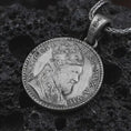 Load image into Gallery viewer, Oxidized Pope Innocent coin pendant necklace resting on black volcanic stone, featuring a papal portrait with Latin inscription in a detailed antique coin-style macro photograph.