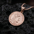 Load image into Gallery viewer, Rose gold plated Pope Innocent coin pendant necklace presented on textured volcanic stone, showcasing the round papal coin silhouette and intricate religious-historical detailing in a refined macro studio shot.