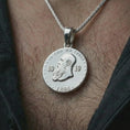 Load image into Gallery viewer, Polished silver heraldic eagle coin pendant necklace worn on the neck, shown in a clean model shot with the round eagle crest pendant centered for a refined heritage-inspired look.