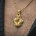 Load image into Gallery viewer, Gold plated Tutankhamun pendant necklace worn on the neck, captured in a premium lifestyle composition that highlights the royal Egyptian motif as a distinctive heritage jewelry accent.