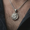 Load image into Gallery viewer, Oxidized Athena owl coin pendant necklace worn on the neck, styled in a dark lifestyle image that presents the ancient Greek owl medallion as a bold symbolic and historical statement piece.