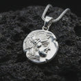 Load image into Gallery viewer, Polished silver Athena owl coin pendant necklace displayed on dark volcanic rock, shown in a premium close-up image that highlights the sacred owl motif and antique coin texture.