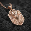 Load image into Gallery viewer, Rose gold plated pharaoh shield pendant necklace on textured volcanic rock, detailed macro product shot with soft warm reflections and ancient Egyptian symbolism.