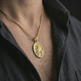 Load image into Gallery viewer, Gold plated Saint Francis pendant necklace worn on the chest, premium lifestyle jewelry photo with the Saint Francis medal centered on a spiga chain.