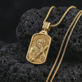 Load image into Gallery viewer, Gold plated Saint Andrew dog tag pendant necklace on textured volcanic rock, premium close-up studio composition emphasizing the apostle figure, cross, and sacred book symbolism.
