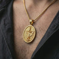 Load image into Gallery viewer, Gold plated Saint Michael pendant necklace worn on the chest, premium lifestyle jewelry photo with the protective archangel medal centered on a spiga chain.
